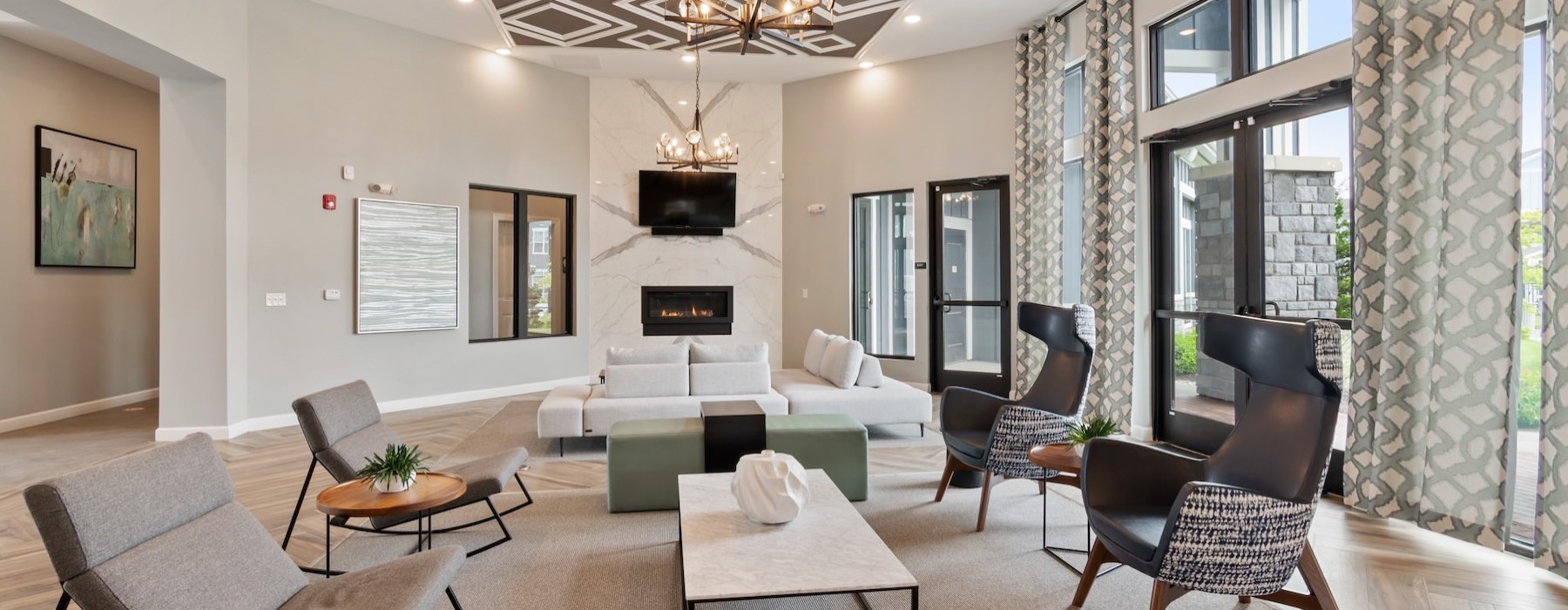 a clubroom with a couch, tables and chairs