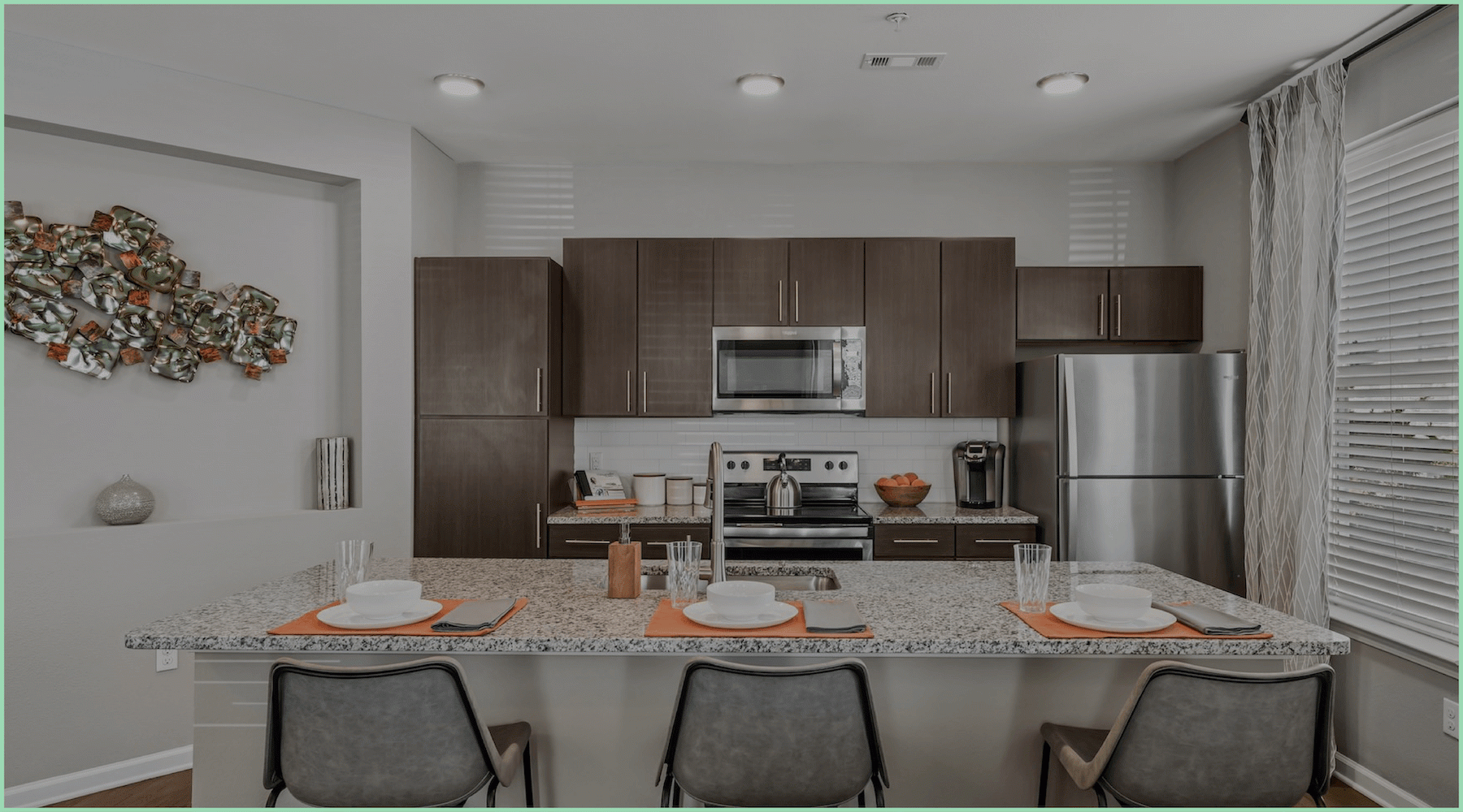 a kitchen with an island and chairs