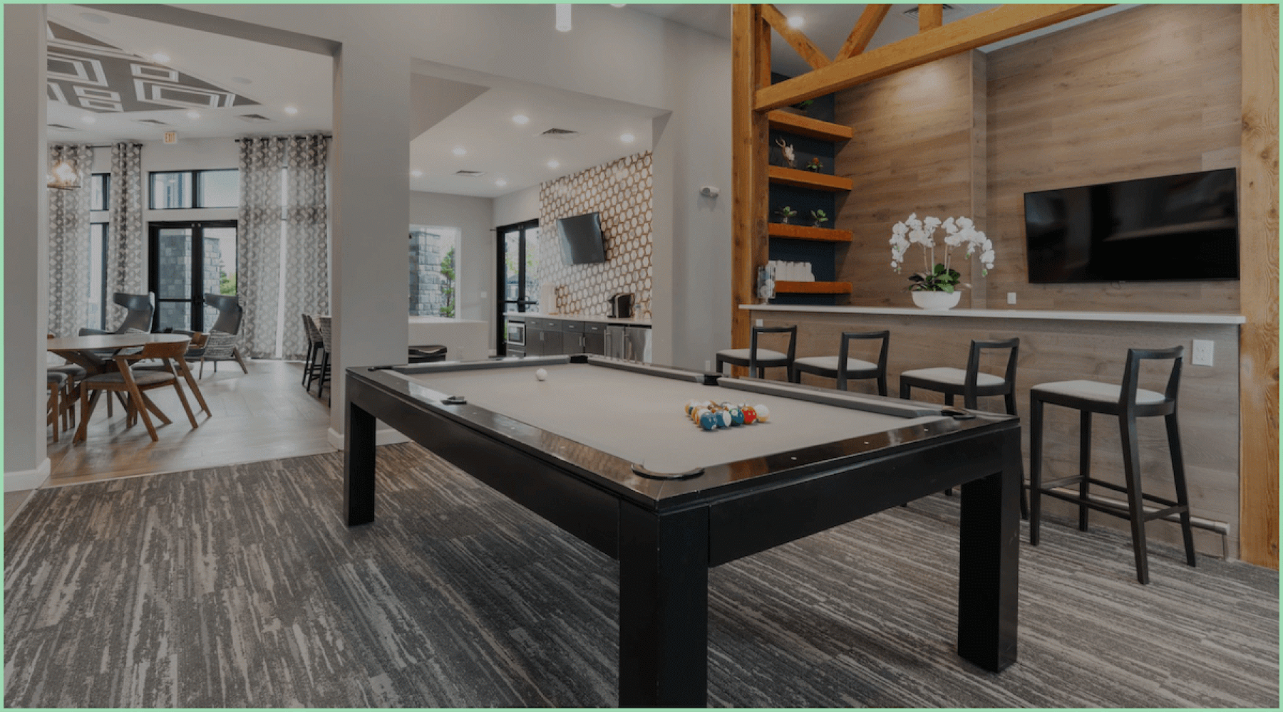 a clubroom with a pool table and chairs