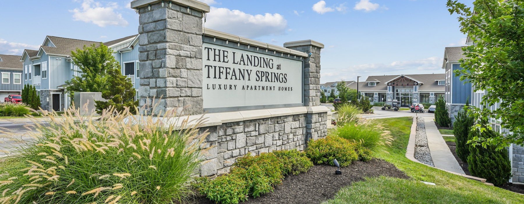 a large sign with grass