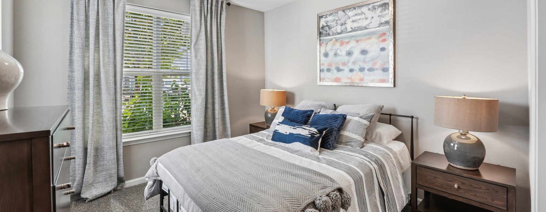 a bedroom with a bed and two nightstands
