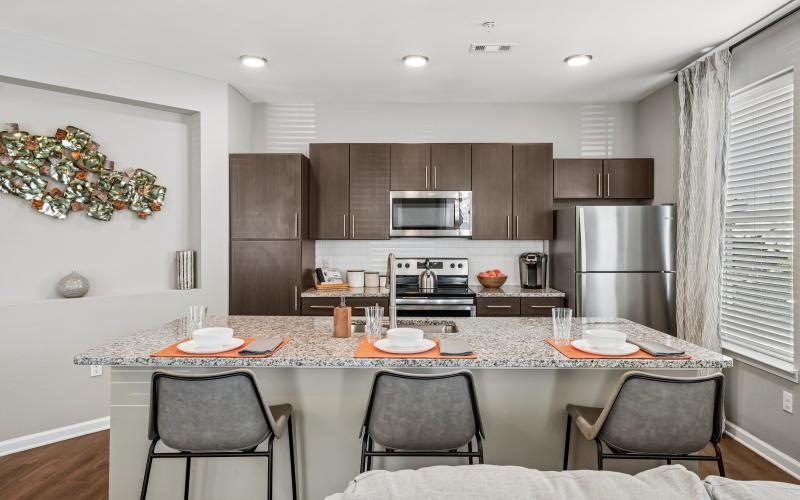 a kitchen with an island and chairs